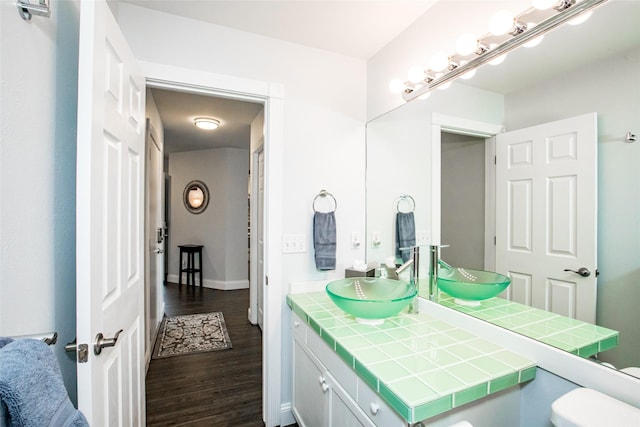883 Saint Andrews Dr, Columbia Falls, MT 59912 - bathroom with wood finished floors, vanity, toilet, and baseboards