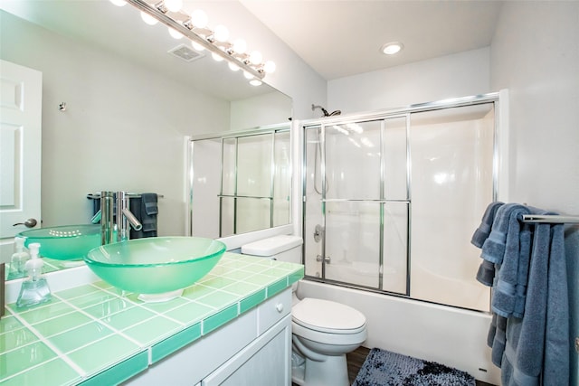 883 Saint Andrews Dr, Columbia Falls, MT 59912 - full bath featuring vanity, toilet, and shower / bath combination with glass door