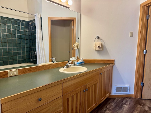 883 Saint Andrews Dr, Columbia Falls, MT 59912 - full bathroom with vanity, shower / bath combo, and wood finished floors