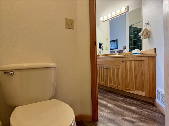 883 Saint Andrews Dr, Columbia Falls, MT 59912 - bathroom featuring toilet, vanity, wood finished floors, baseboards, and a shower