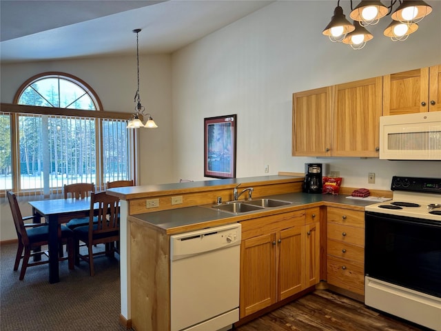 883 Saint Andrews Dr, Columbia Falls, MT 59912 - kitchen featuring white appliances, a sink, a chandelier, a peninsula, and hanging light fixtures