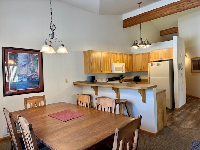 883 Saint Andrews Dr, Columbia Falls, MT 59912 - dining room featuring a chandelier, high vaulted ceiling, beam ceiling, baseboards, and dark colored carpet