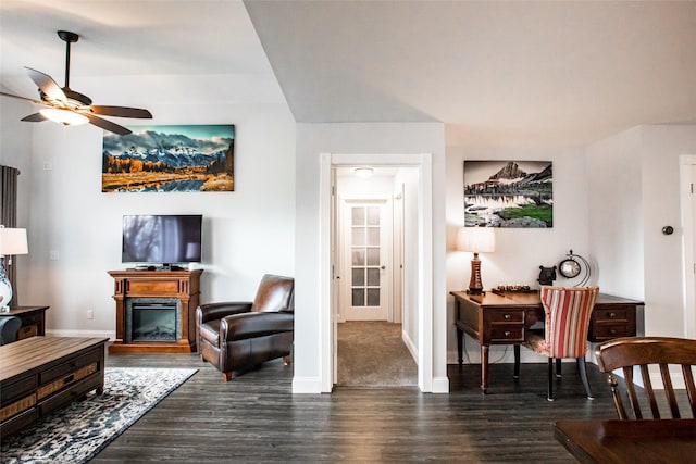 883 Saint Andrews Dr, Columbia Falls, MT 59912 - living room featuring dark wood-type flooring, a ceiling fan, baseboards, and a glass covered fireplace