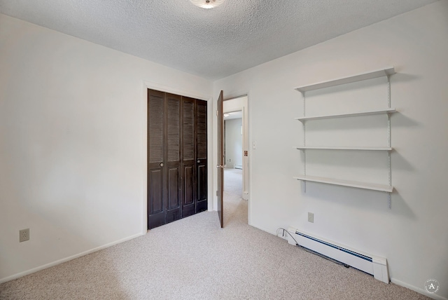 15 Vigilante Trl, Clancy, MT 59634 - unfurnished bedroom with a baseboard radiator, carpet flooring, a closet, a textured ceiling, and baseboards