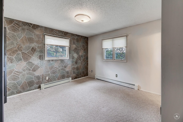 15 Vigilante Trl, Clancy, MT 59634 - unfurnished room with a baseboard radiator, carpet flooring, healthy amount of natural light, and a textured ceiling