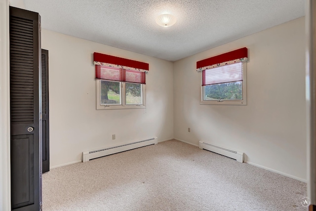 15 Vigilante Trl, Clancy, MT 59634 - unfurnished bedroom with baseboard heating, carpet flooring, multiple windows, and a textured ceiling