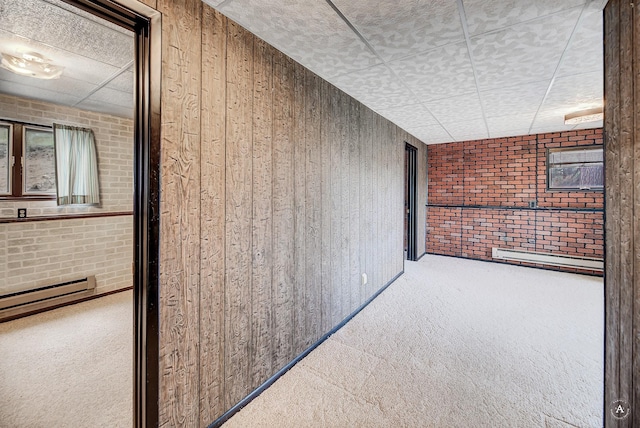 15 Vigilante Trl, Clancy, MT 59634 - hall with carpet, brick wall, wood walls, and a baseboard radiator
