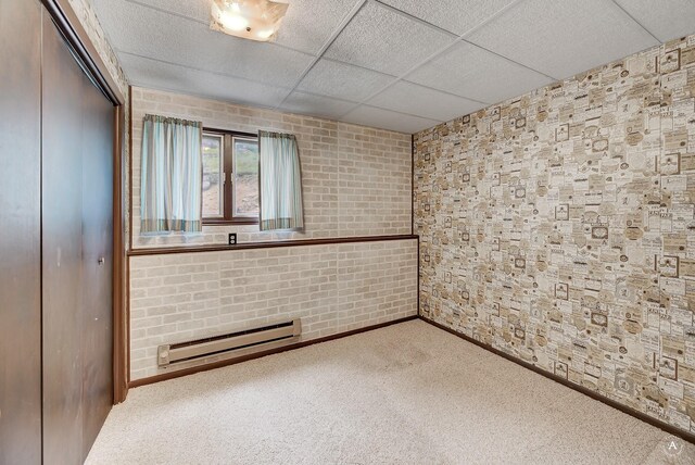 15 Vigilante Trl, Clancy, MT 59634 - carpeted spare room featuring a baseboard heating unit, a paneled ceiling, and baseboards