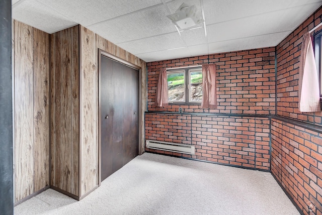 15 Vigilante Trl, Clancy, MT 59634 - carpeted empty room featuring brick wall, baseboard heating, and wood walls