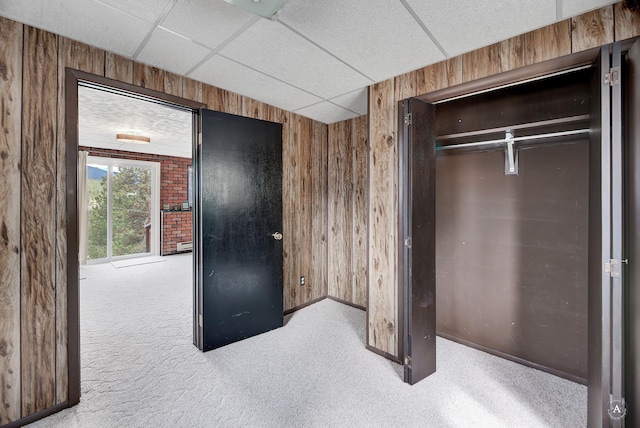 15 Vigilante Trl, Clancy, MT 59634 - unfurnished bedroom featuring carpet floors, wood walls, a paneled ceiling, a closet, and baseboards