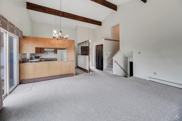 15 Vigilante Trl, Clancy, MT 59634 - kitchen with freestanding refrigerator, a baseboard radiator, a chandelier, light colored carpet, and high vaulted ceiling
