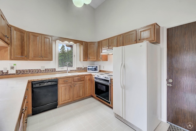 15 Vigilante Trl, Clancy, MT 59634 - kitchen with white appliances, a towering ceiling, a sink, under cabinet range hood, and light countertops
