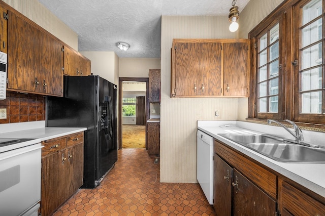414 Somers Ave, Whitefish, MT 59937 - kitchen with white appliances, a sink, light countertops, a textured ceiling, and backsplash