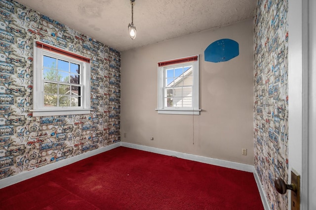414 Somers Ave, Whitefish, MT 59937 - carpeted spare room with healthy amount of natural light, wallpapered walls, baseboards, and a textured ceiling