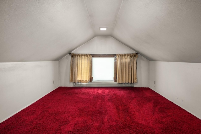 414 Somers Ave, Whitefish, MT 59937 - bonus room featuring vaulted ceiling, carpet, and a textured ceiling
