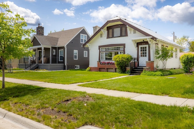 414 Somers Ave, Whitefish, MT 59937 - view of front of property featuring a front yard, a chimney, and a porch