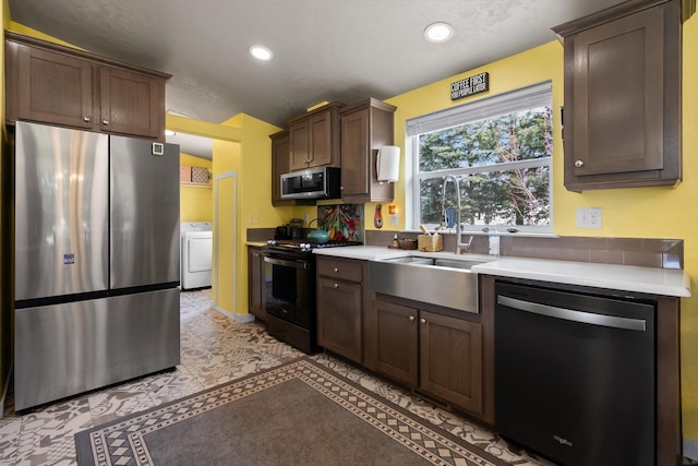245 Blanchard Lake Rd, Whitefish, MT 59937 - kitchen featuring appliances with stainless steel finishes, washer / dryer, light countertops, recessed lighting, and dark brown cabinets