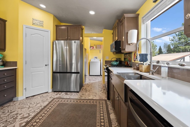 245 Blanchard Lake Rd, Whitefish, MT 59937 - kitchen with stainless steel appliances, washer / dryer, light countertops, and recessed lighting