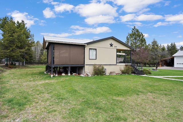 245 Blanchard Lake Rd, Whitefish, MT 59937 - view of side of home with a lawn, stairs, and a garage