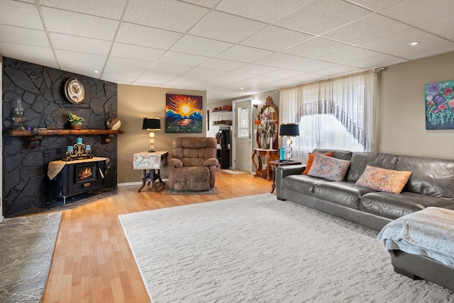245 Blanchard Lake Rd, Whitefish, MT 59937 - living room with a drop ceiling, a wood stove, and wood finished floors