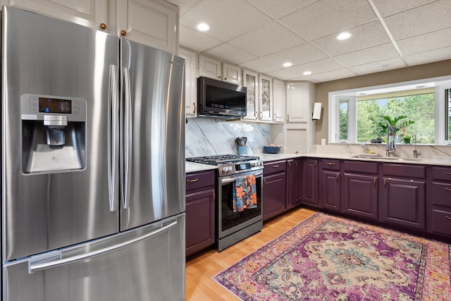 245 Blanchard Lake Rd, Whitefish, MT 59937 - kitchen featuring stainless steel appliances, light countertops, light wood-style flooring, recessed lighting, and tasteful backsplash