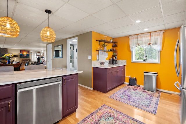 245 Blanchard Lake Rd, Whitefish, MT 59937 - kitchen featuring stainless steel appliances, light wood-style floors, a paneled ceiling, open floor plan, and pendant lighting