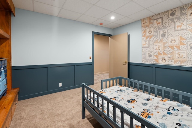 245 Blanchard Lake Rd, Whitefish, MT 59937 - bedroom with a drop ceiling, a decorative wall, a wainscoted wall, light carpet, and recessed lighting