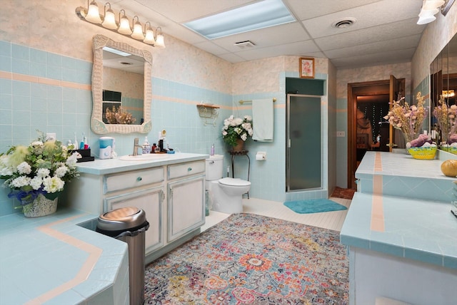 245 Blanchard Lake Rd, Whitefish, MT 59937 - bathroom with vanity, a stall shower, tile walls, and tile patterned flooring