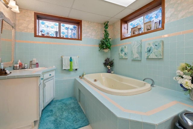 245 Blanchard Lake Rd, Whitefish, MT 59937 - full bathroom with vanity, a jetted tub, healthy amount of natural light, and tile walls