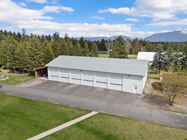 245 Blanchard Lake Rd, Whitefish, MT 59937 - garage featuring a mountain view and a view of trees