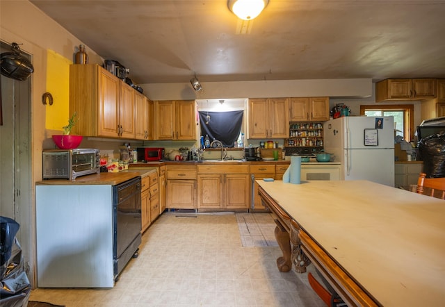 103 6th St, Alberton, MT 59820 - kitchen featuring freestanding refrigerator, a sink, and dishwasher
