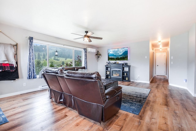 30 Knapp Ln, Kalispell, MT 59901 - living room featuring an AC wall unit, a ceiling fan, a baseboard radiator, wood finished floors, and baseboards