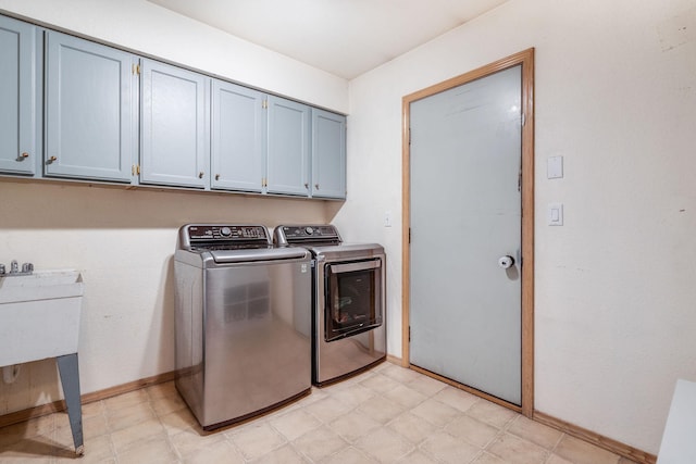 30 Knapp Ln, Kalispell, MT 59901 - laundry area featuring cabinet space, independent washer and dryer, light floors, and baseboards