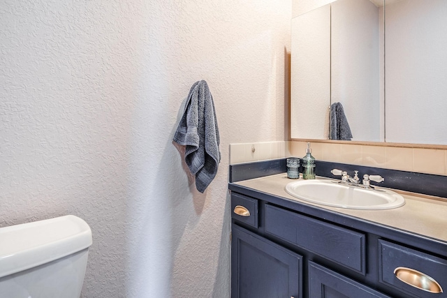 30 Knapp Ln, Kalispell, MT 59901 - half bath featuring a textured wall, vanity, and toilet