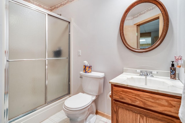 30 Knapp Ln, Kalispell, MT 59901 - bathroom with toilet, vanity, a shower with shower door, and baseboards
