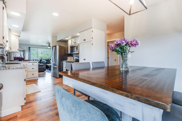 30 Knapp Ln, Kalispell, MT 59901 - kitchen featuring appliances with stainless steel finishes, white cabinets, light wood-style flooring, a ceiling fan, and recessed lighting