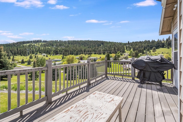 30 Knapp Ln, Kalispell, MT 59901 - wooden terrace with a view of trees, a lawn, and a grill