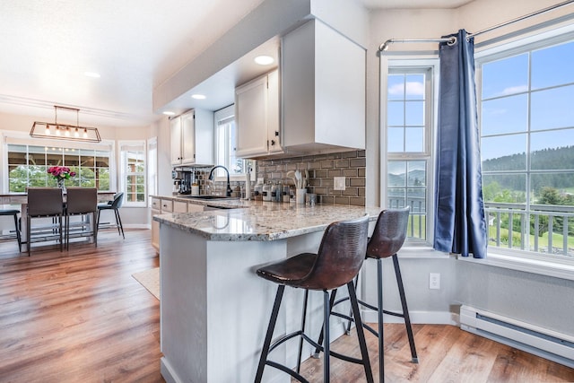 30 Knapp Ln, Kalispell, MT 59901 - kitchen featuring baseboard heating, healthy amount of natural light, decorative backsplash, baseboards, and recessed lighting