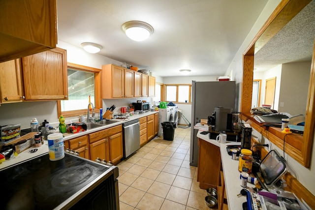 312 12th Ave N, Shelby, MT 59474 - kitchen with appliances with stainless steel finishes, a sink, light tile patterned floors, and light countertops