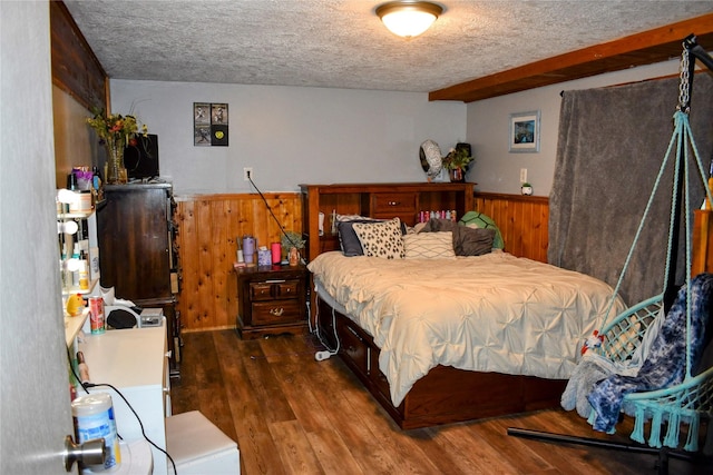 83 Indian Head Rd, Libby, MT 59923 - bedroom featuring wood walls, a textured ceiling, a wainscoted wall, and wood finished floors
