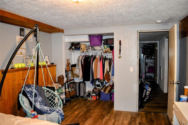 83 Indian Head Rd, Libby, MT 59923 - bedroom featuring wood finished floors, a closet, and a textured ceiling