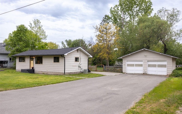 215 Tower St, Missoula, MT 59804 - view of front of house featuring a garage, an outdoor structure, and central air condition unit