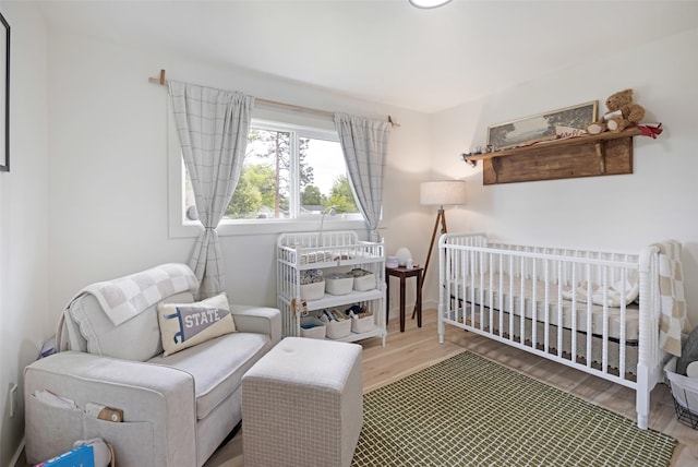 215 Tower St, Missoula, MT 59804 - bedroom featuring wood finished floors and a nursery area