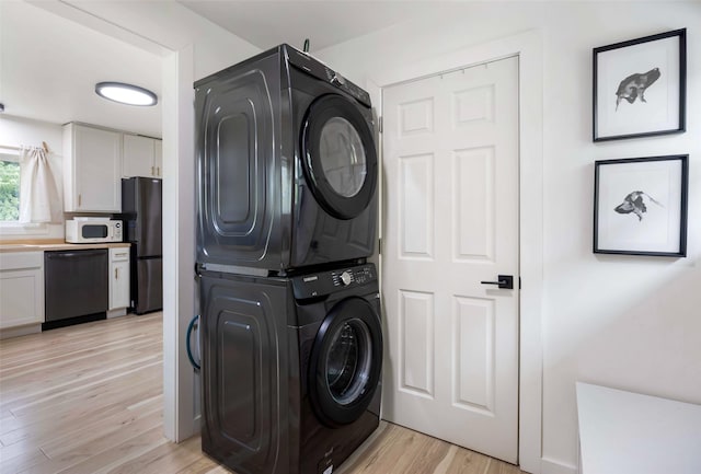 215 Tower St, Missoula, MT 59804 - washroom featuring stacked washer and clothes dryer and light wood finished floors