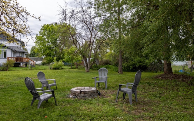 215 Tower St, Missoula, MT 59804 - view of grassy yard with an outdoor fire pit and a wooden deck