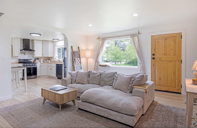 215 Tower St, Missoula, MT 59804 - living area featuring arched walkways, light wood-type flooring, and recessed lighting