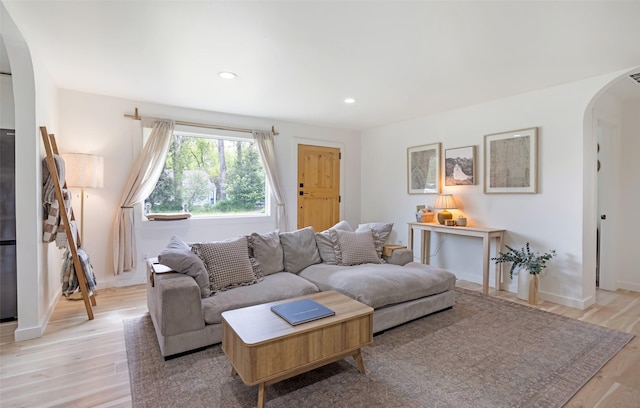 215 Tower St, Missoula, MT 59804 - living room featuring arched walkways, light wood-style floors, recessed lighting, and baseboards