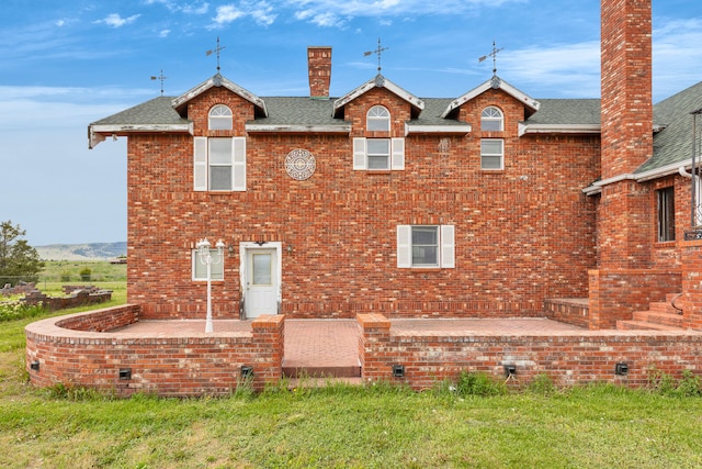 33562 Fox Rd, Polson, MT 59860 - rear view of house with a chimney, brick siding, and a shingled roof