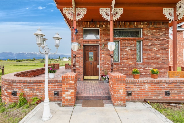 33562 Fox Rd, Polson, MT 59860 - view of exterior entry with brick siding and a porch