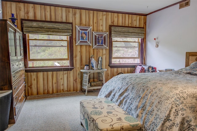 8229 York Rd, Helena, MT 59602 - bedroom featuring crown molding, multiple windows, wooden walls, and light colored carpet